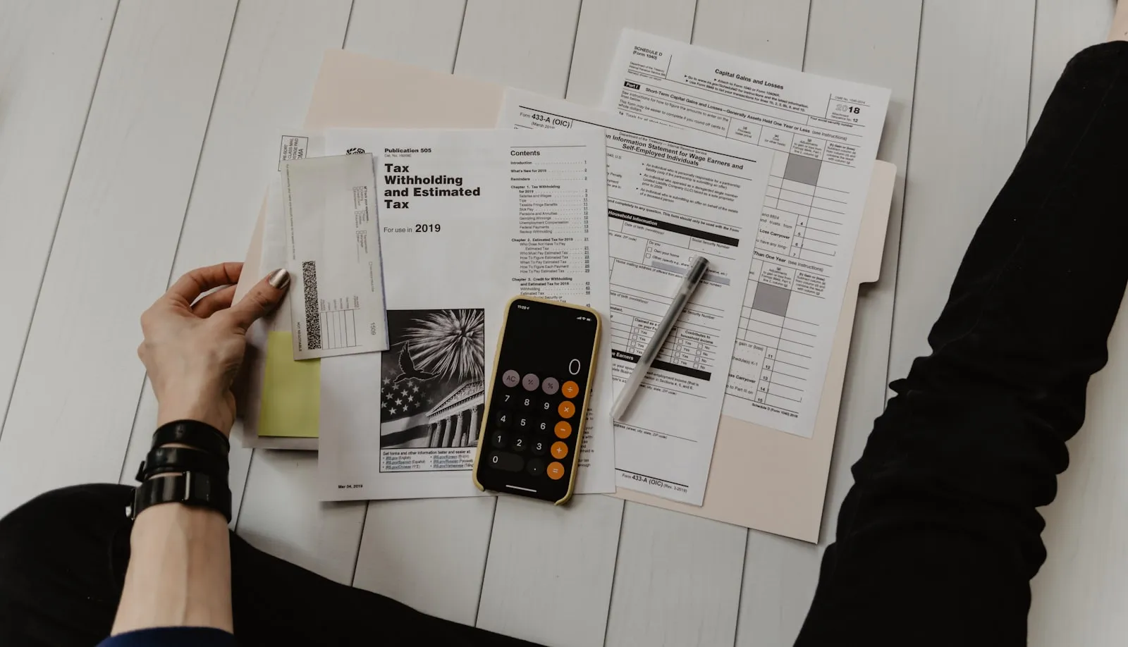 Blue Cross Blue Shield insurance card on a desk next to a notebook and pen